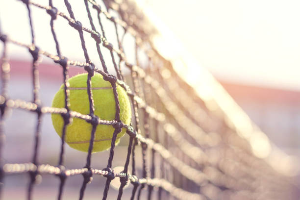 istock Close up Tennis ball hitting to net 912833454