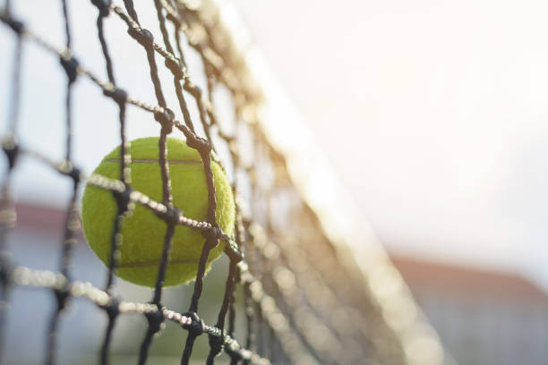 istock Close up Tennis ball hitting to net 912833464