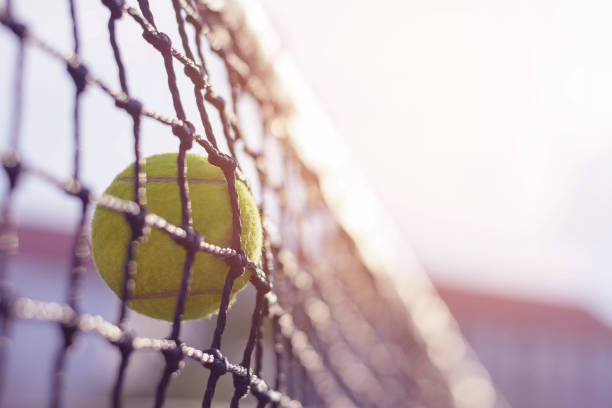 istock Close up Tennis ball hitting to net 912833468