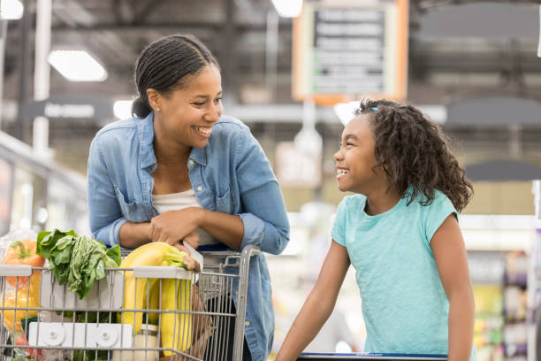 istock Mom and daughter bond while shopping 912835976