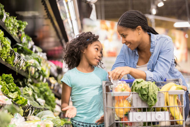 istock Young girl shops with her mom 912835990