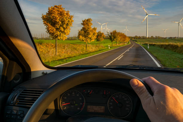 istock driver behind the wheel driving down a country road 912842074