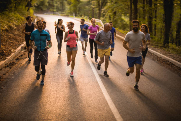 istock Large group of athletes talking while having a road running race. 912859624