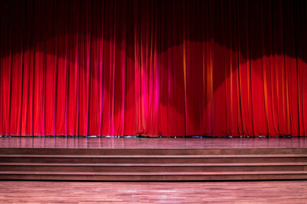 Stage wood with ladder and red curtains in a theater.