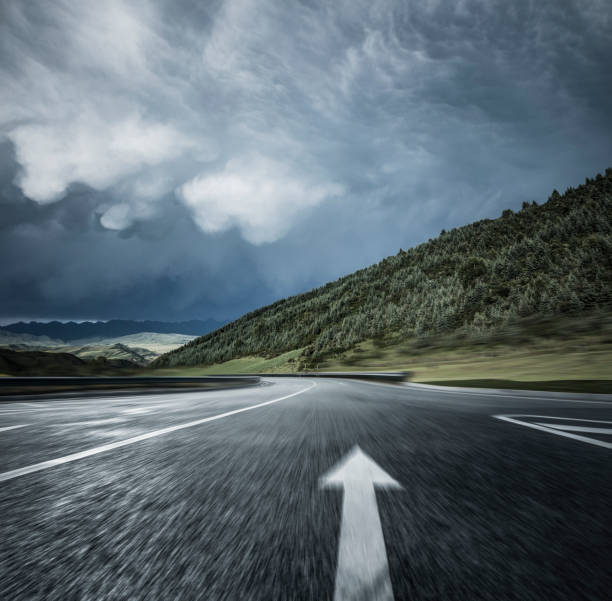 istock blurred motion of mountain road against overcast sky 912864258