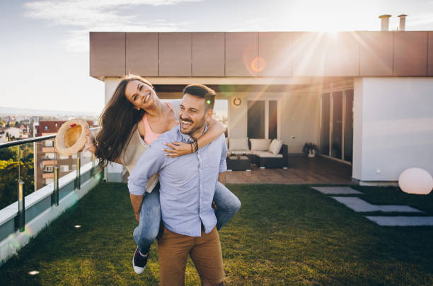 istock Happy couple having fun while piggybacking on a penthouse terrace. 912866466