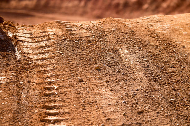 istock Traces from the car on the red clay soil 912867028