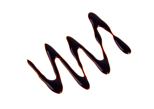 istock Liquid dark chocolate isolated on white background, silhouette of drawn chocolate zigzag 912867136