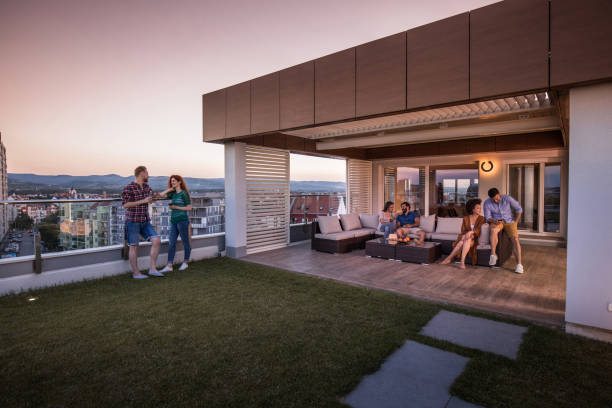 istock Three young couples enjoying in a day on a penthouse patio. 912867160