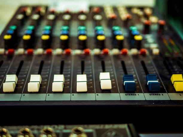 istock macro shot of Professional audio equipment with faders knobs and buttons