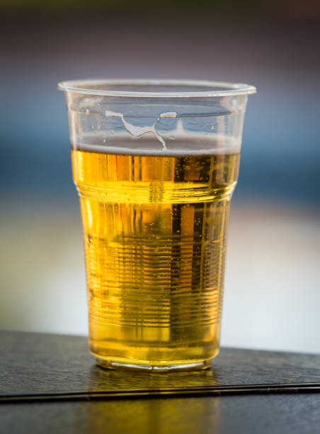 istock Fresh beer in a plastic glass on the table 912867594