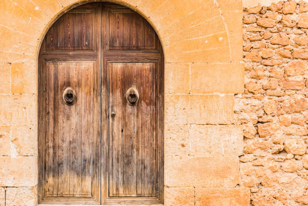 istock House door with stone arch and wall background 912867776