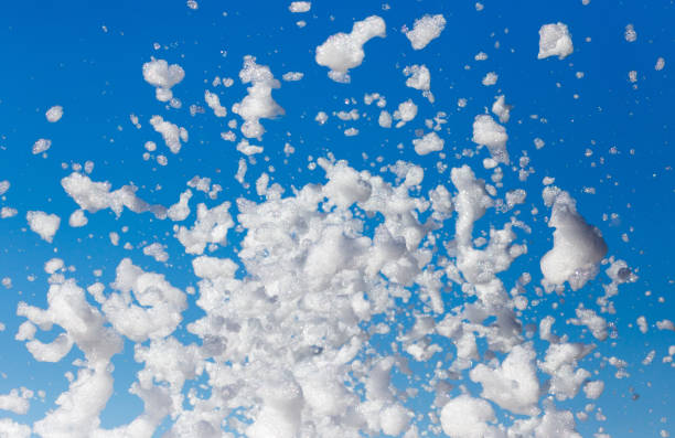 istock White foam against the blue sky as background 912867822