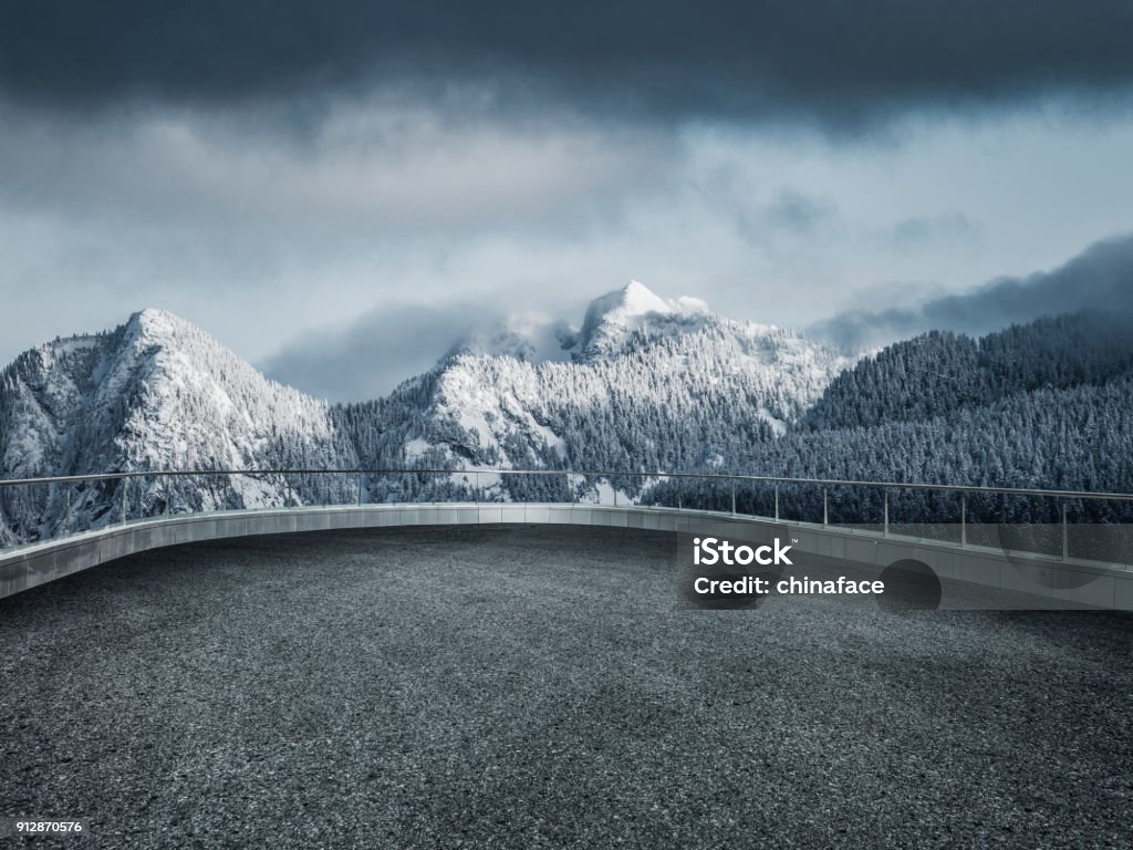 winding snowy road leading towards snow mountains shot at Yukon,Canada. Observation Point Stock Photo