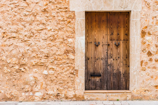 istock Rustic mediterranean house with stone wall and old wooden door 912871226