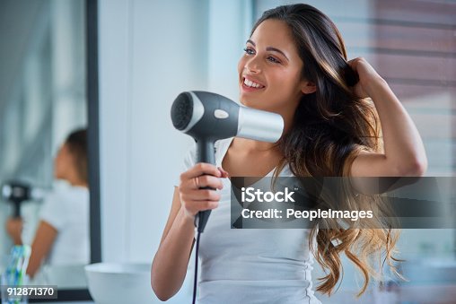 istock Putting great care into her hair 912871370