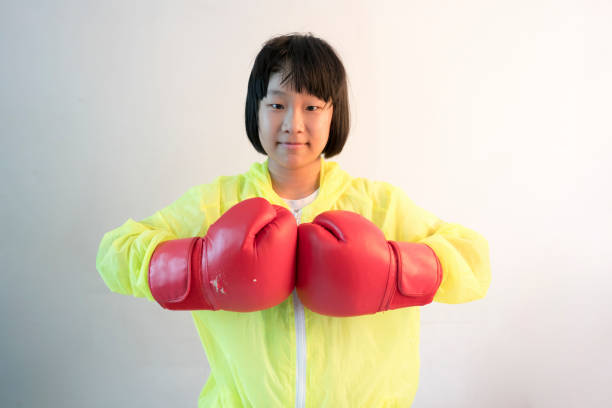 asian girl with red boxing glove with white background