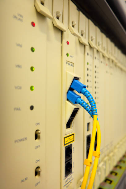 istock Fiber optic cable connected to Private Automatic Branch eXchange telephone system on rack tower . PABX . selective focus 912872418