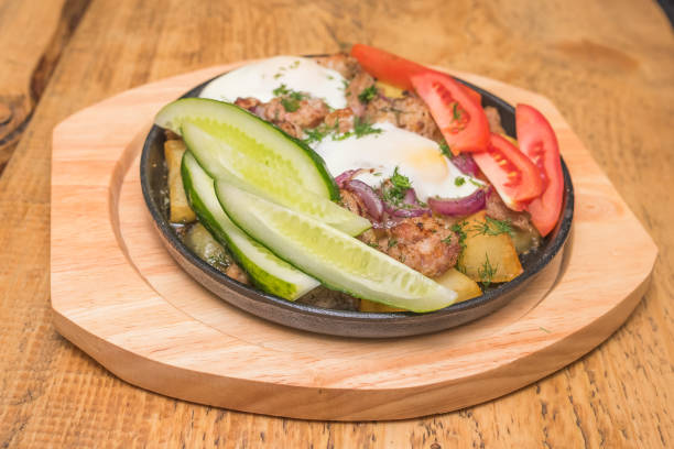 istock Potatoes with meat and cucumber in the pan 912878796