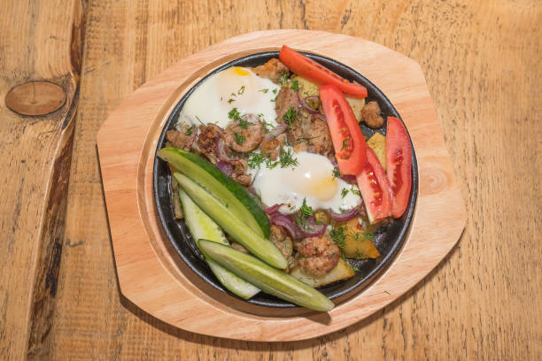istock Potatoes with meat and cucumber in the pan 912879380