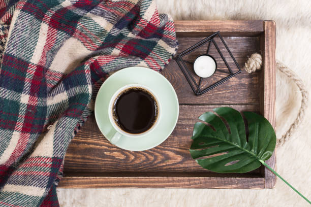 istock Coffee cup, tray on wooden background with a blank notepad 912885666