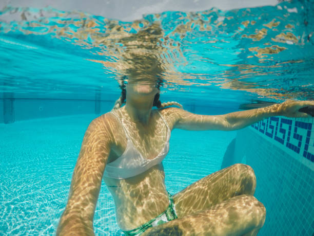 istock Women swimming in the pool 912889686