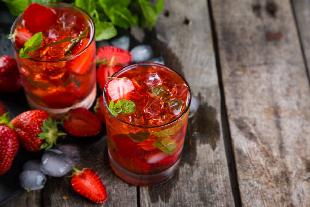 istock Strawberry mojito and ingredients on rustic background 912889772
