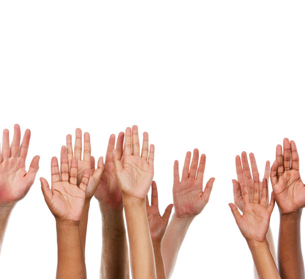 istock Many hands held aloft against white background 912889848