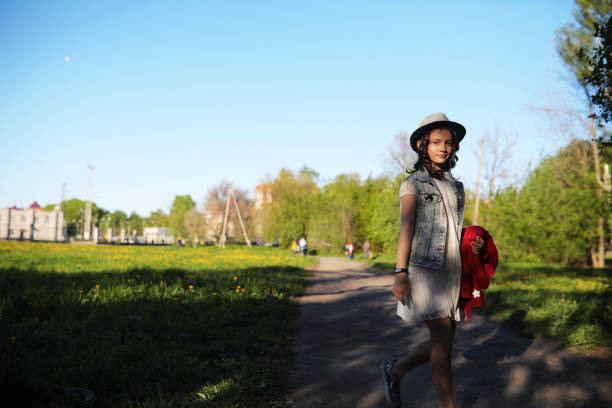 Girl in the park in the evening of a sunny day in the spring