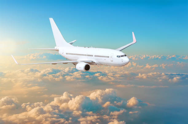 istock Flying airplane above the clouds horizon sky with bright sunset colors. 912894206