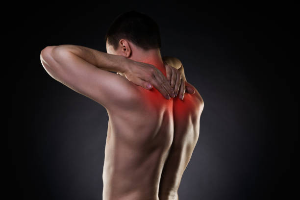 istock Neck pain, man with backache on black background 912894878