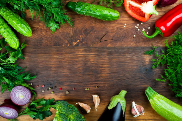istock Raw vegetables on wooden texture background with copyspace in center 912897316