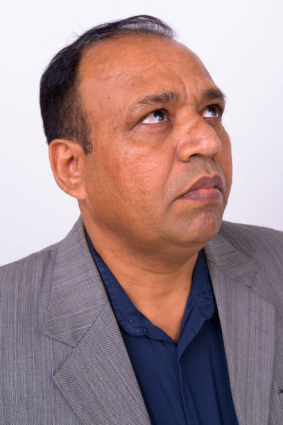 istock Face Of Indian Businessman Thinking Against White Background 912898578