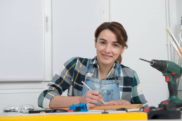 istock pretty young woman doing DIY work at home 912899192