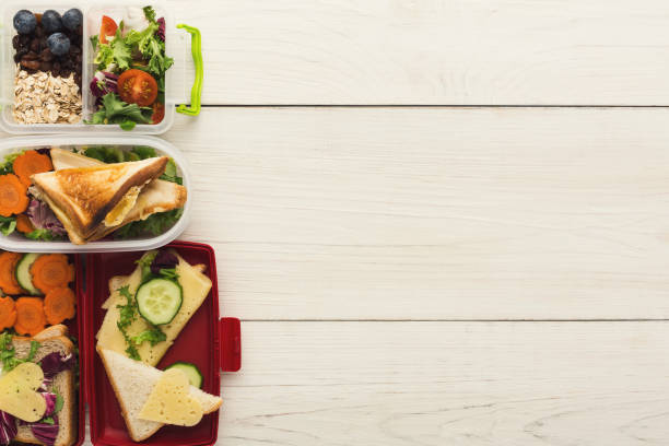 istock Various kunch boxes top view on white wooden boards 912899572