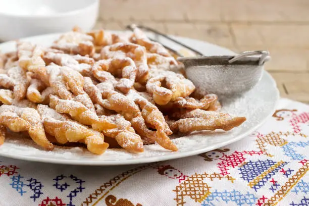 Angel wings biscuits, a traditional European sweet dish for carnival. Rustic style, selective focus.