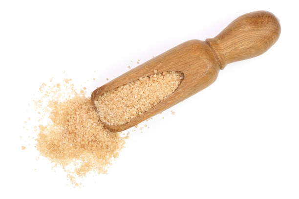 istock brown sugar in wooden scoop isolated on white background. Top view. Flat lay 912899710