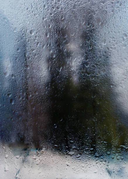 istock Rainy autumn landscape through a window with raindrops. 912903280