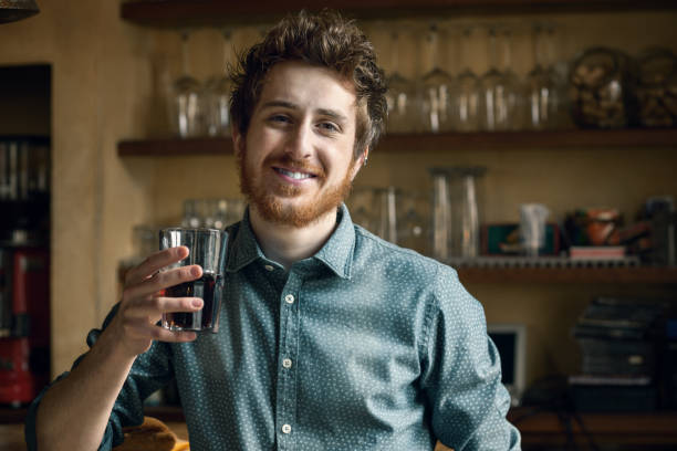 Hipster man drinking a glass of coke