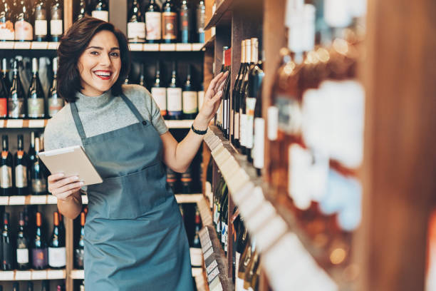 istock Cheerful young woman in a wine store 912903924