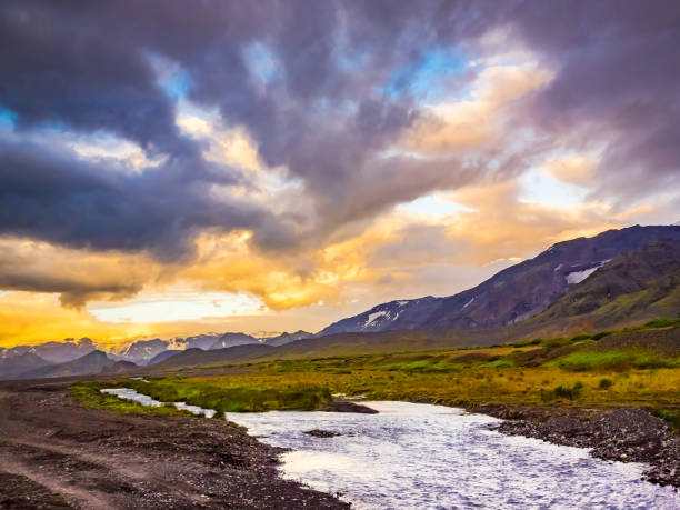 istock Beautiful sunrise over mountain and a small stream 912910190