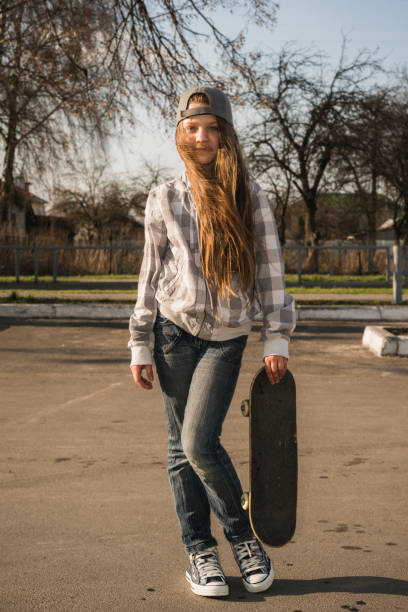 istock girl with skateboard on street 912911314