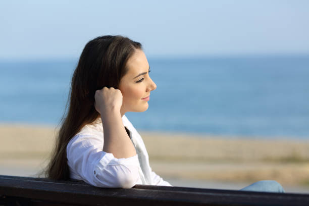 istock Pensive woman looking away on the beach 912915846