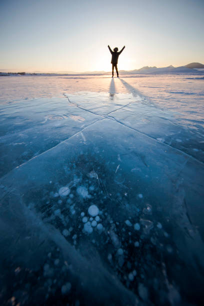 istock Man on a frozen lake 912916804