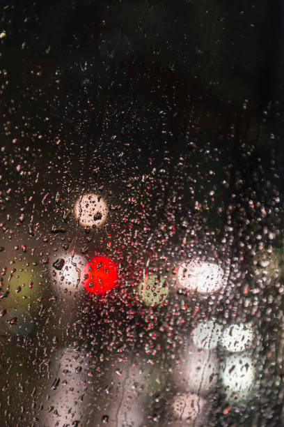 istock Traffic lights seen through a rainy glass pane 912919378