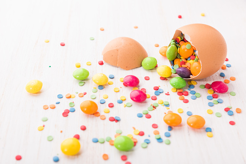 Broken chicken egg shell on white wooden background