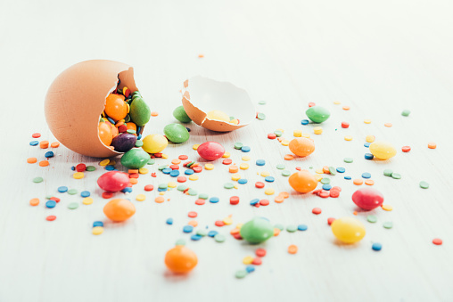 Broken chicken egg shell on white wooden background