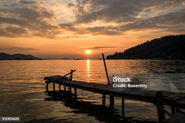 Tropical Sunrise With Wooden Jetty Over Island Stock Photo - Download Image Now - 2017, Achievement, Beginnings