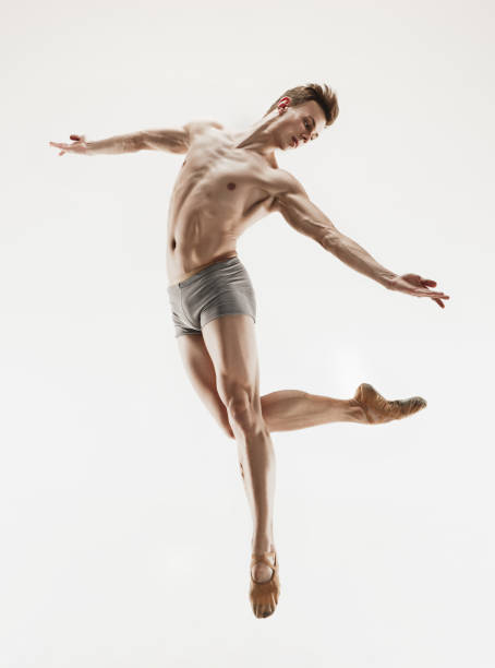 istock Athletic ballet dancer in a perfect shape performing over the grey background 912925236