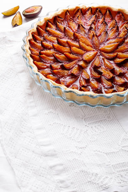 istock Homemade plum pie. Fruit tart on white table. Copy space. 912927834